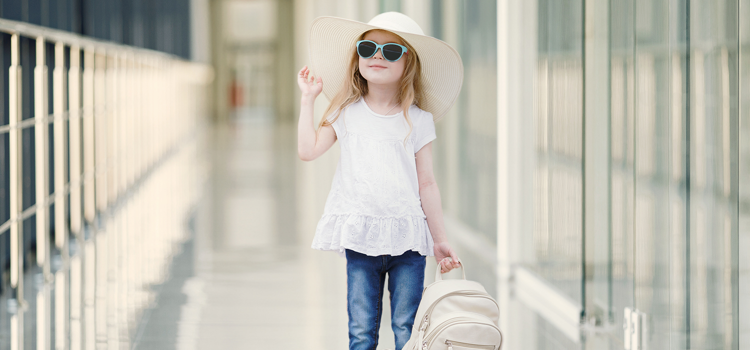 A smiling child walking in the airport