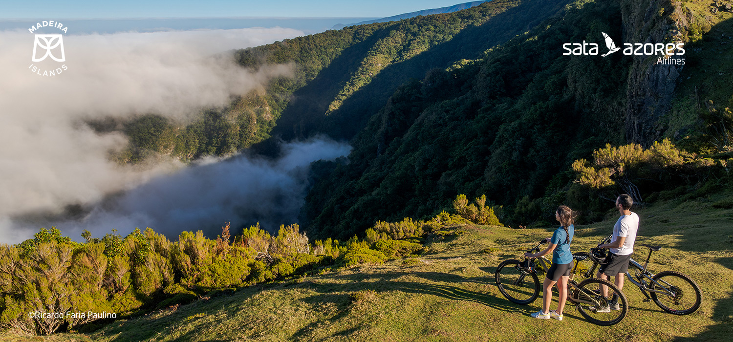 Couple riding a bike in the beautiful nature of Madeira island.