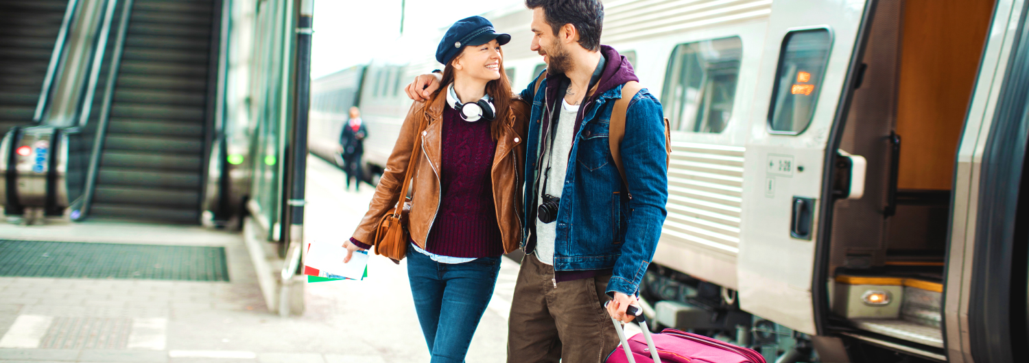 Tourists couple in a train station. Rail & Fly